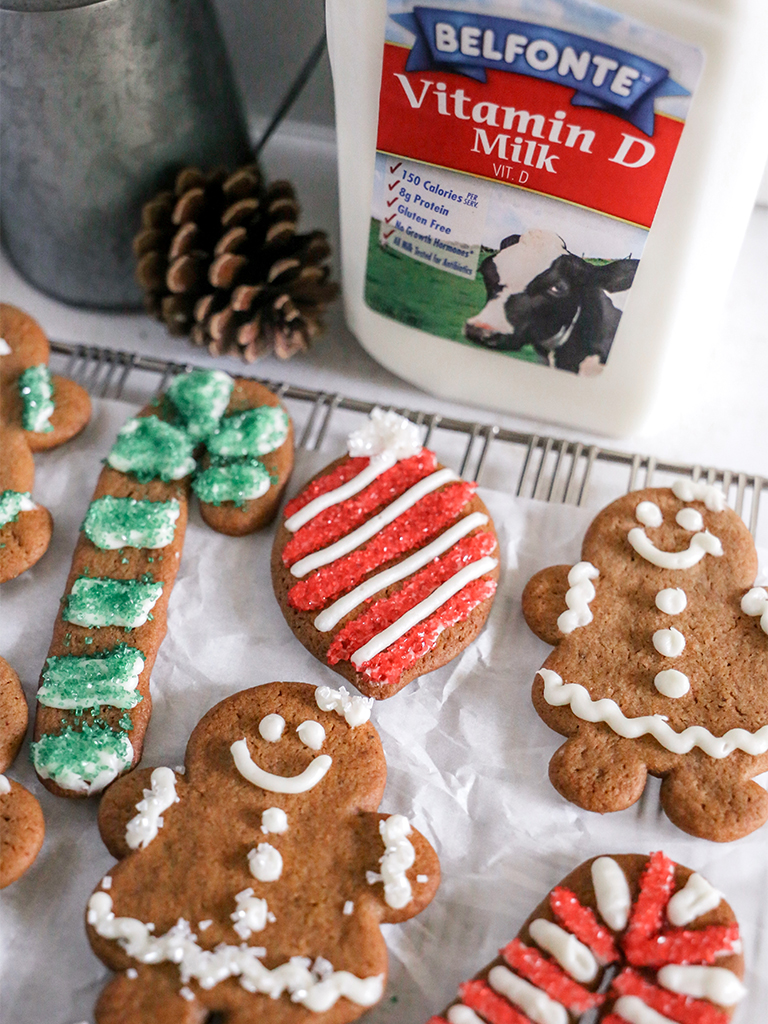 Gingerbread cookies decorated with cream cheese frosting and colorful sprinkles.